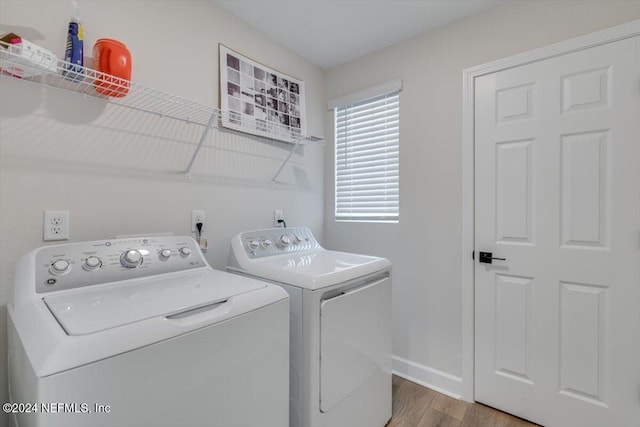 washroom with separate washer and dryer and hardwood / wood-style floors