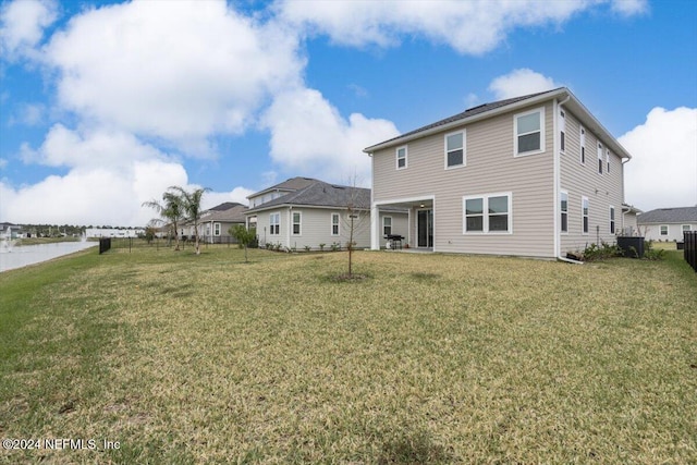 rear view of house with a lawn