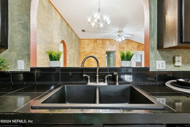 kitchen featuring ceiling fan with notable chandelier, lofted ceiling, and sink