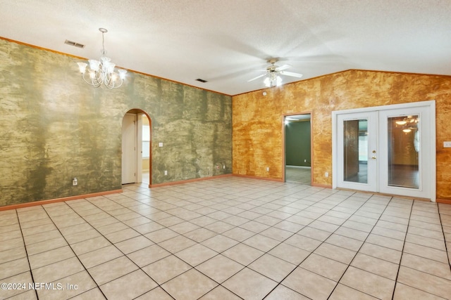 spare room featuring ceiling fan with notable chandelier, light tile patterned floors, a textured ceiling, and french doors