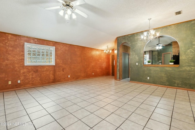 tiled empty room with a textured ceiling, ceiling fan with notable chandelier, and vaulted ceiling