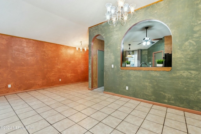 tiled empty room with ceiling fan with notable chandelier and lofted ceiling