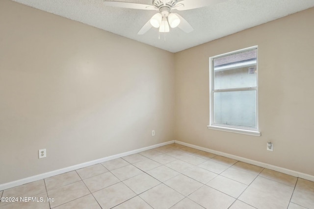 tiled spare room featuring ceiling fan and a textured ceiling