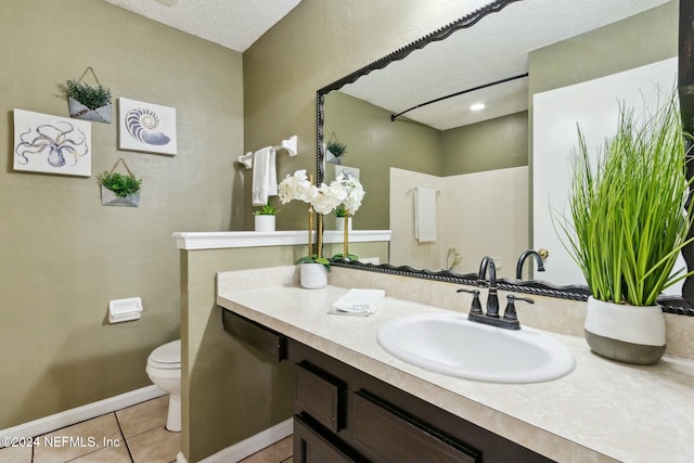 bathroom featuring walk in shower, tile patterned flooring, a textured ceiling, toilet, and vanity