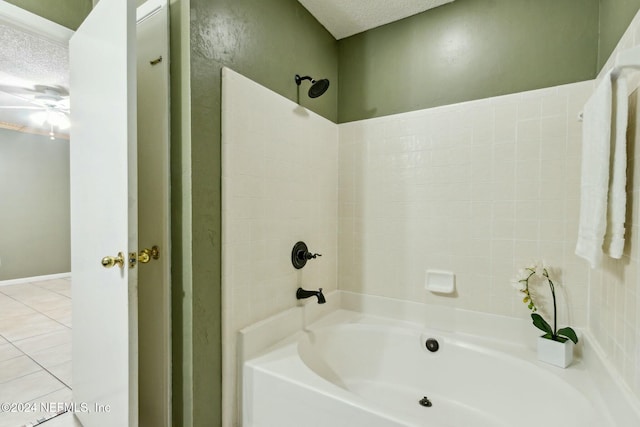 bathroom with tile patterned floors, shower / bath combination, and a textured ceiling