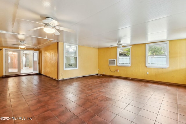 spare room featuring tile patterned floors and a wall unit AC