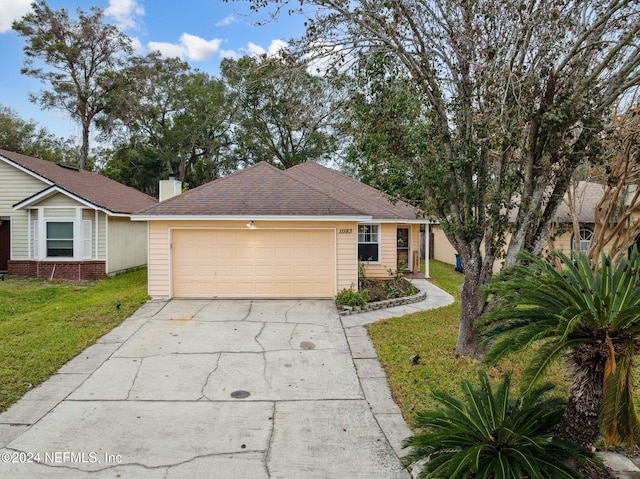 ranch-style home featuring a garage and a front lawn