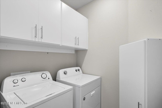 laundry area featuring cabinets and independent washer and dryer