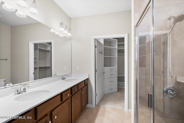 bathroom with vanity, tile patterned floors, and walk in shower