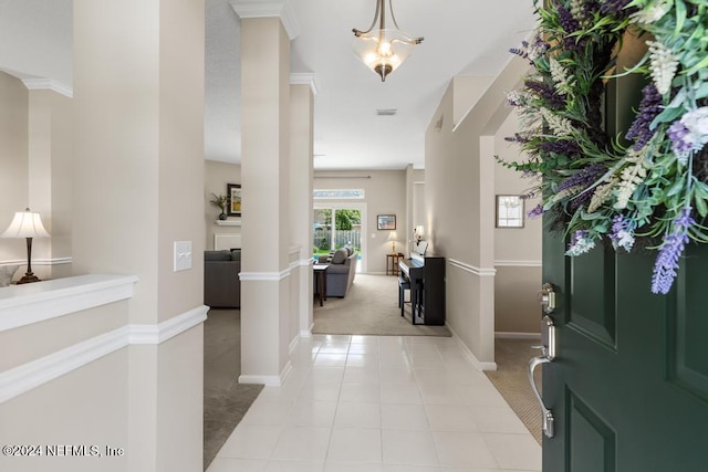 entryway featuring light carpet and crown molding