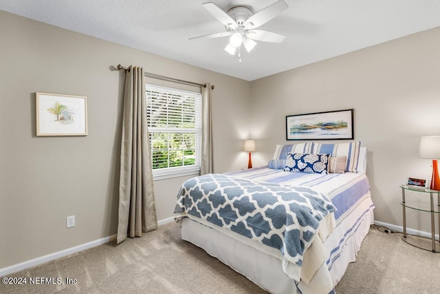 bedroom featuring ceiling fan and light carpet