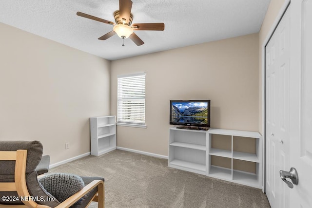 interior space with a textured ceiling and ceiling fan