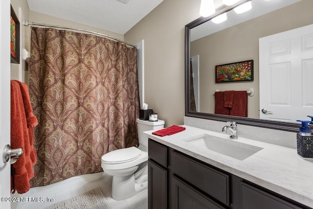 bathroom featuring tile patterned floors, vanity, and toilet