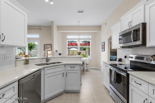 kitchen with sink, white cabinetry, and stainless steel appliances