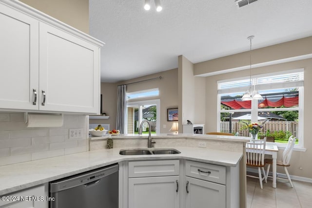 kitchen featuring stainless steel dishwasher, white cabinets, and sink