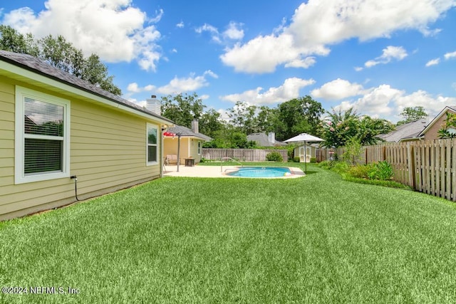 view of yard featuring a fenced in pool and a patio area