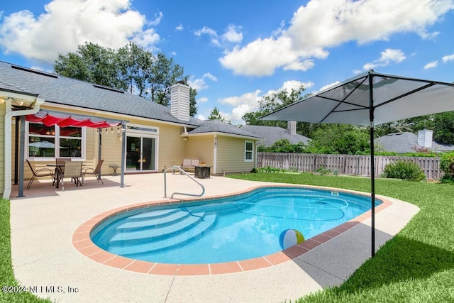 view of pool with a yard and a patio