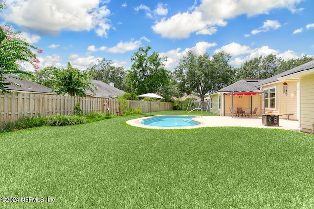 view of yard with a fenced in pool, an outdoor fire pit, a patio area, and central air condition unit