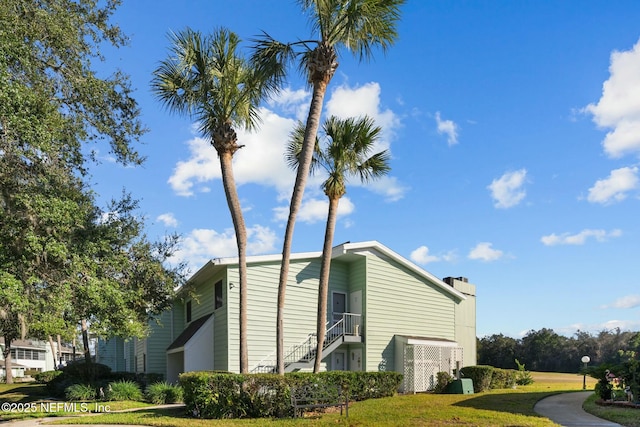 view of property exterior with a lawn