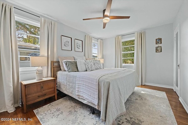 bedroom with ceiling fan and dark hardwood / wood-style flooring