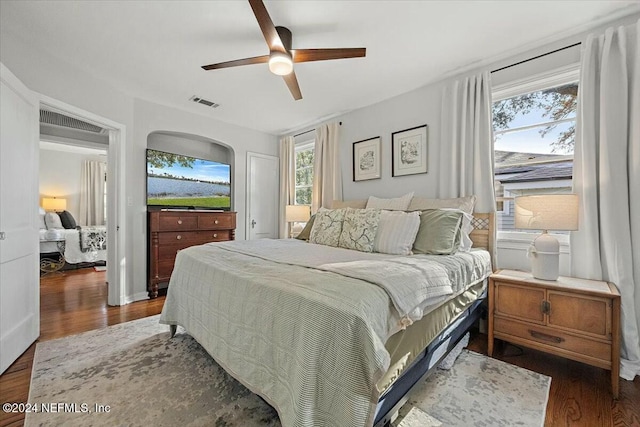 bedroom with ceiling fan and dark hardwood / wood-style floors