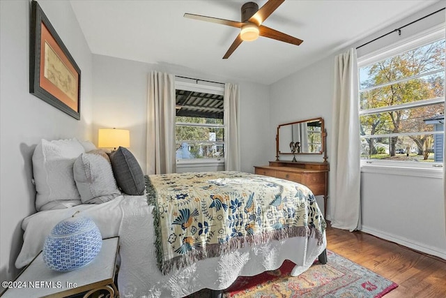 bedroom featuring multiple windows, ceiling fan, and wood-type flooring