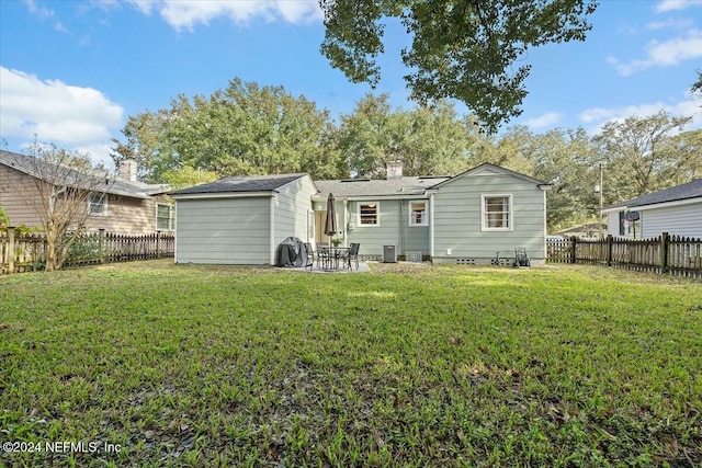 back of house featuring a yard, a patio, and central AC