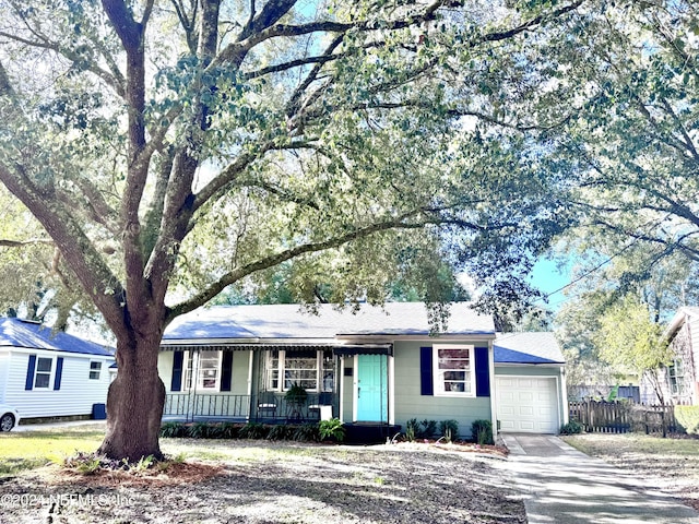 single story home featuring covered porch and a garage