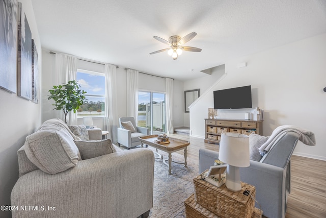 living room featuring ceiling fan and hardwood / wood-style flooring