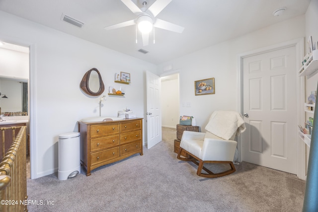 sitting room with light carpet, ceiling fan, and sink