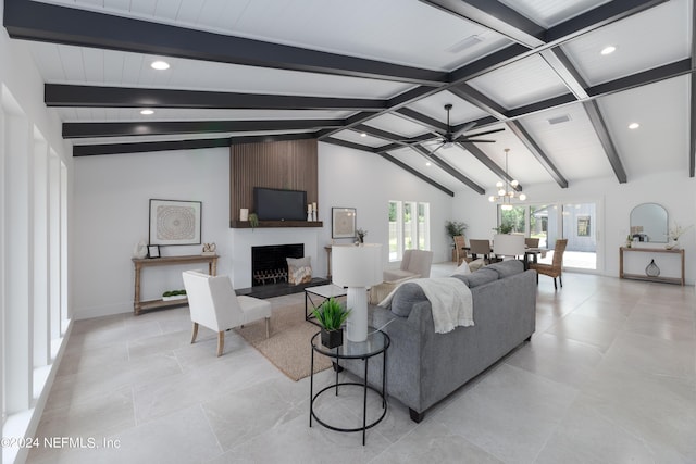 living room with a fireplace, beamed ceiling, ceiling fan with notable chandelier, and high vaulted ceiling