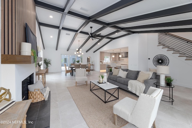 tiled living room with lofted ceiling with beams and ceiling fan with notable chandelier