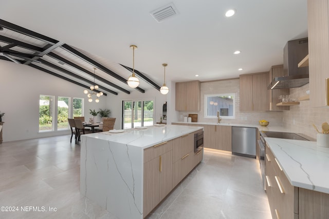 kitchen featuring vaulted ceiling with beams, light stone countertops, a kitchen island, and appliances with stainless steel finishes