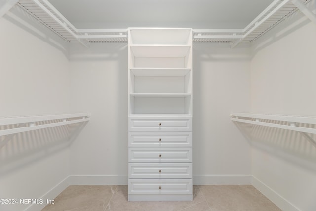 spacious closet featuring light tile patterned flooring