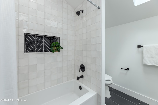 bathroom featuring tile patterned floors, toilet, and shower / tub combo with curtain