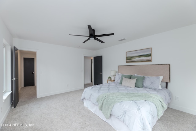 bedroom featuring light carpet and ceiling fan