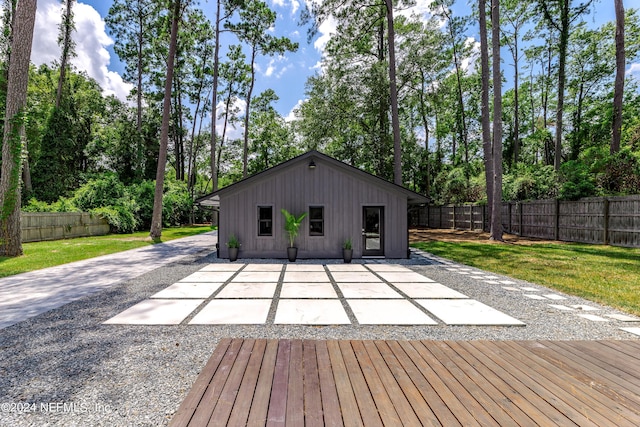 exterior space with a yard, a patio, and an outdoor structure