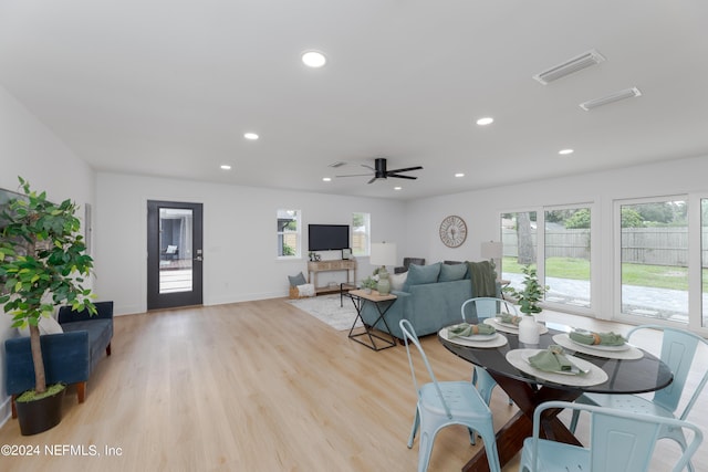 dining room with ceiling fan and light hardwood / wood-style floors