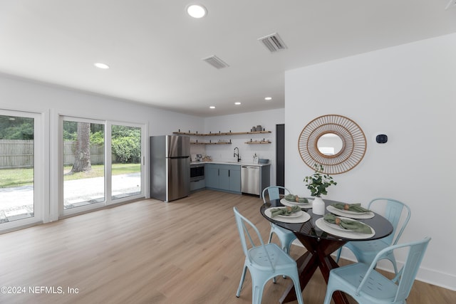 dining area featuring light hardwood / wood-style floors and sink