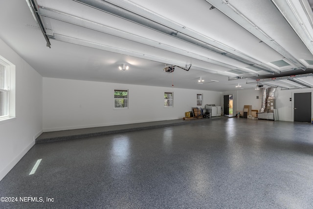 garage featuring heating unit and a garage door opener