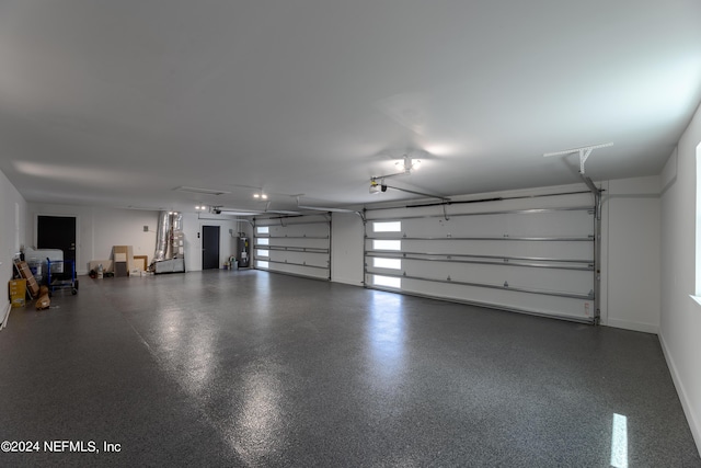 garage with electric water heater and a garage door opener