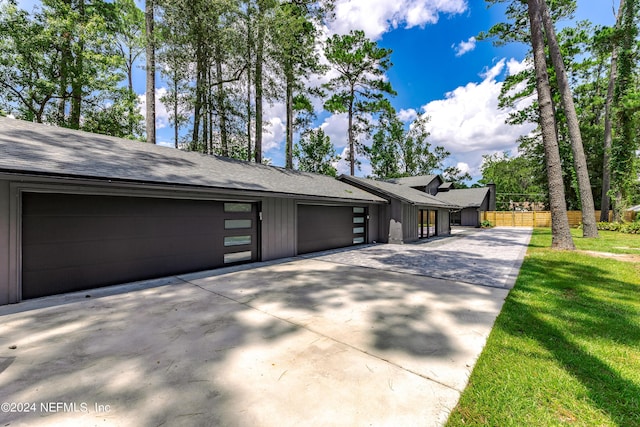 exterior space with a yard and a garage