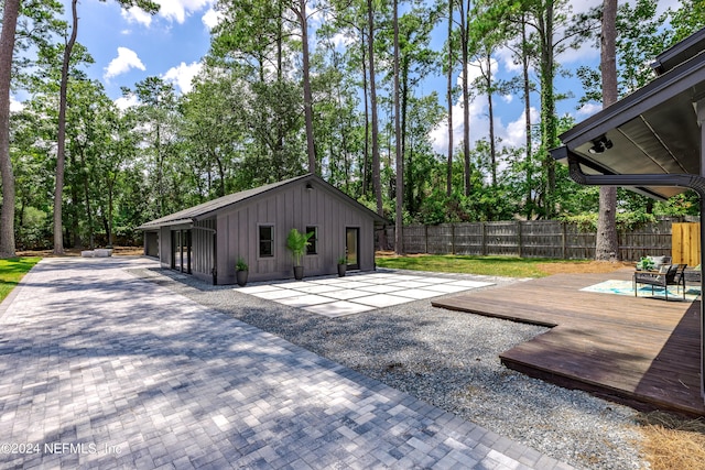 view of patio / terrace with an outdoor structure and a deck