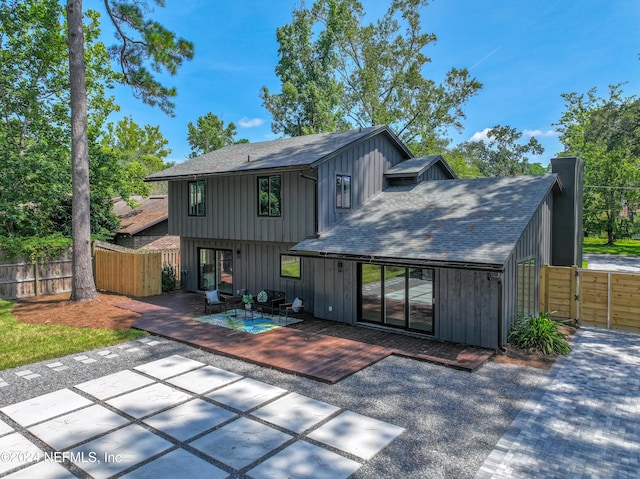 back of property featuring an outdoor hangout area and a deck