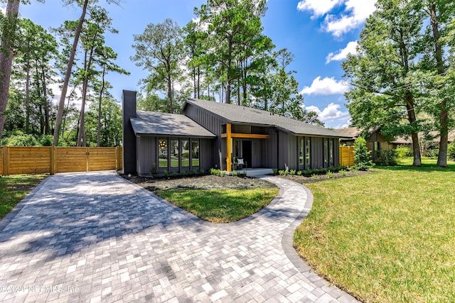 contemporary home featuring a front lawn