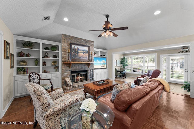 living room featuring a fireplace, dark parquet floors, vaulted ceiling, and ceiling fan