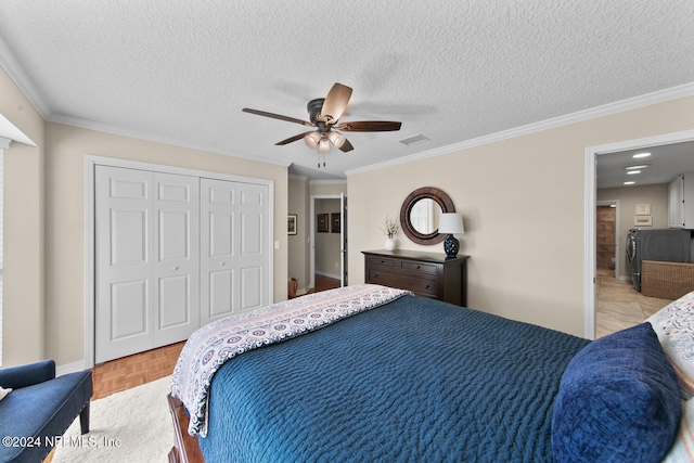 bedroom with ceiling fan, crown molding, light parquet floors, a textured ceiling, and a closet