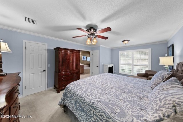 bedroom featuring a textured ceiling, ceiling fan, crown molding, and light carpet