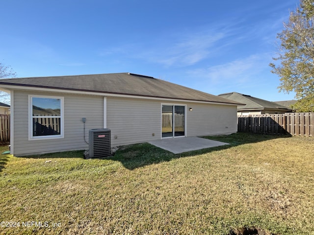 back of house with a patio, central AC unit, and a lawn