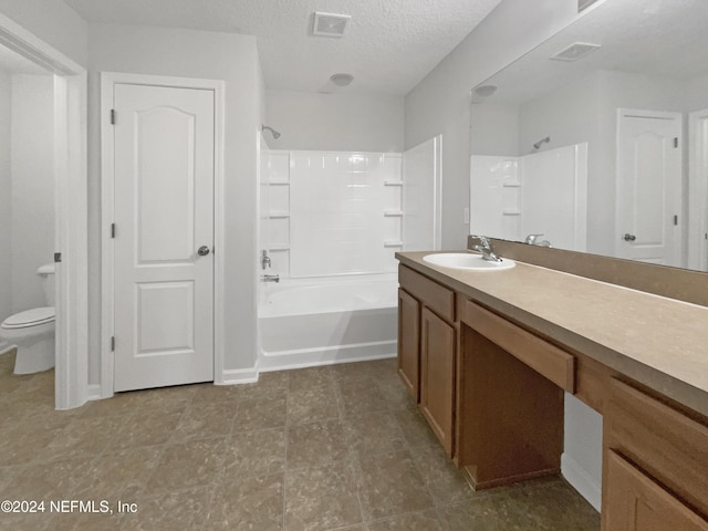 full bathroom with vanity, toilet, a textured ceiling, and bathtub / shower combination